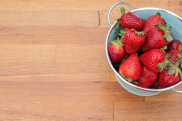Fresh organic strawberries just picked from the garden in within a beautiful vintage pastel light blue font.