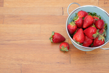 Fresh organic strawberries just picked from the garden in within a beautiful vintage pastel light blue font.