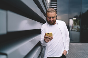 Glad man browsing internet on smartphone