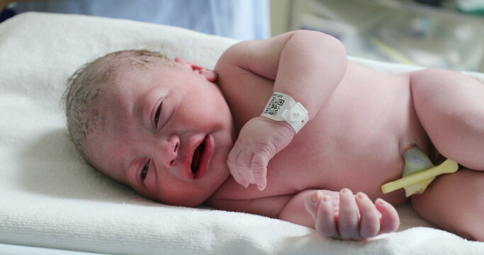 Infant newborn baby crying after birth, first seconds of life