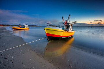 Fishing boats on the beach of Baltic Sea in Sopot at dusk, Poland