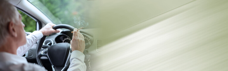Man smoking a cigarette while driving; panoramic banner