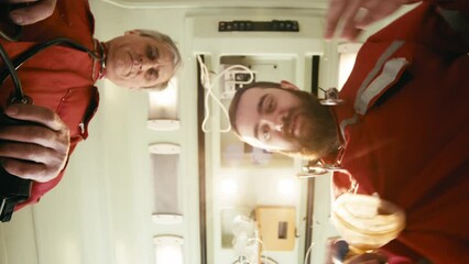 First person. The patient sees several health care workers checking their breathing and putting on a breathing mask. Carrying out first medical aid to the patient. Resuscitation, first aid, medicine.