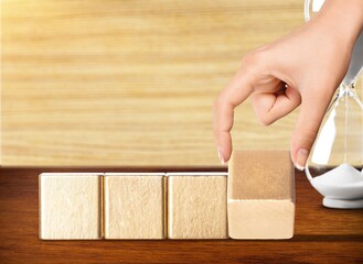 Flipping wooden block 2023 to 2024 concept with hourglass