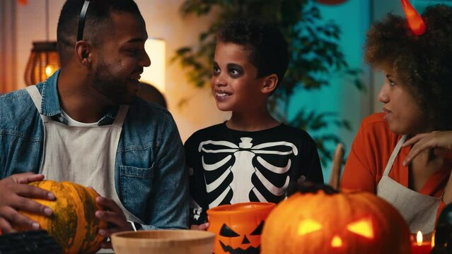Boy with trick or treat basket asking parents for candy, Halloween traditions