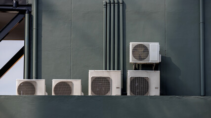 Air conditioner compressor installed in old building. Outdoor split wall type air conditioner...