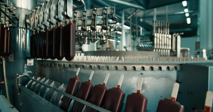 Automated ice cream production line. Chocolate ice cream on a conveyor belt.