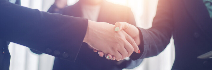 Business woman shaking hands and businessman to make business investment contract agreement...