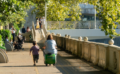 Mom rides a scooter baby catches up
