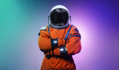 Spaceman on abstract bright background. Astronaut on modern neon background. Sci-fi space wallpaper with bright light and man in spacesuit. Elements of this image furnished by NASA