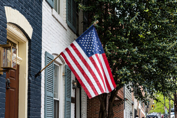 American flag in front of residential area in Georgetown, Washington D.C., USA