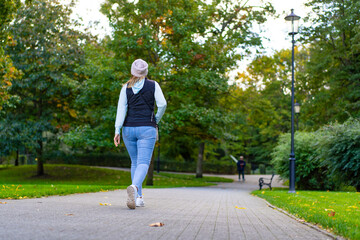 Healthy lifestyle - woman walking in city park
