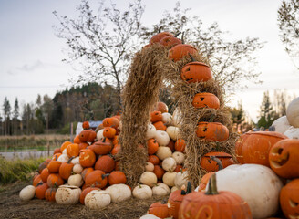 Arch decoration with straw and pumpkins at Halloween Pumpkin event.