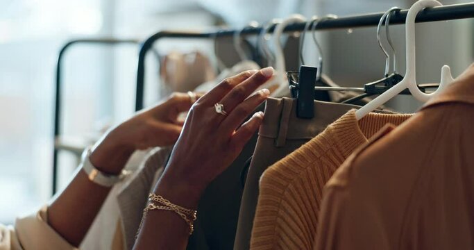 Shopping, sale and hands of woman with clothes, search or outfit choice at boutique or thrift store. Fashion, decision and lady customer looking for discount, deal or checking fabric quality at mall
