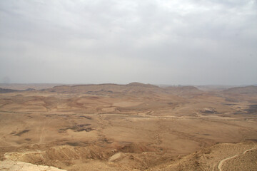 Fototapeta na wymiar Open Negev Desert in South Israel. Sand dunes with dry air on a summer day.