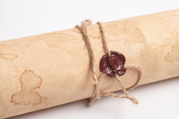 Scroll of vintage paper with sealing wax isolated on white.