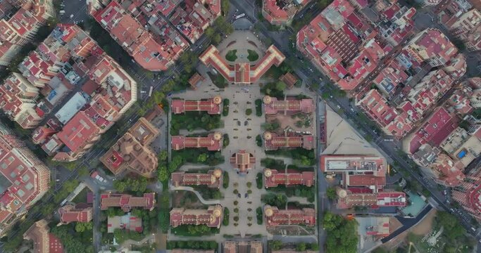 Cinematic aerial of Barcelona city skyline. Drone fly over Eixample residential famous urban grid and Hospital of Sant Pau with morning sunrise cityscape. Catalonia, Spain. Travel Destination.