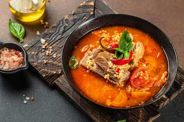 bulgur soup with tomatoes and ribs in bowl. Restaurant menu, dieting, cookbook recipe top view