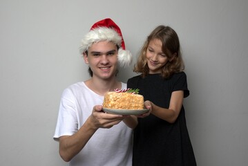 Children brother and sister holding Christmas sweet treat cake