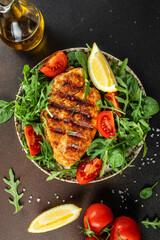 Roasted Chicken Fillet, green lettuce, arugula, tomatoes. Ketogenic diet. Low carb high fat breakfast. Healthy food concept. place for text, top view