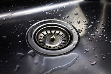 Drain in stainless steel sink with a mesh lid close-up - obrazy, fototapety, plakaty