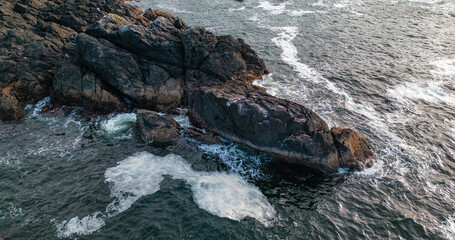 Rocky Shore on the Pacific Ocean Coast. Sunny Sunset.