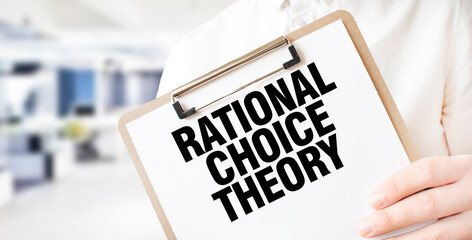 Text RATIONAL CHOICE THEORY on white paper plate in businessman hands in office. Business concept