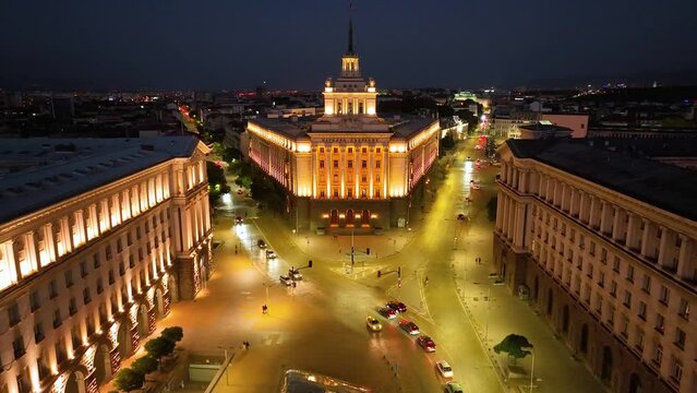 4K Aerial night view of capital of Bulgaria - Sofia. Three architectural and iconic buildings of the communist era. Council of Ministers, Presidency and Party home Current Parliament building. Forward