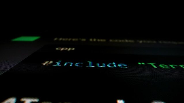 Closeup macro shot movement of coding script moving across LED screen with real-time AI-generated typing, showcasing advanced AI learning in optimization, debug and coding for software development.