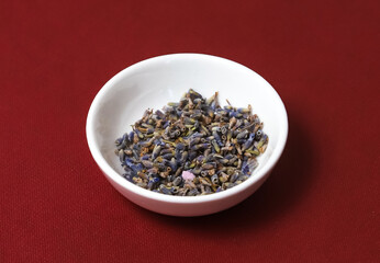 Dried lavender flowers in a white plate. Close-up