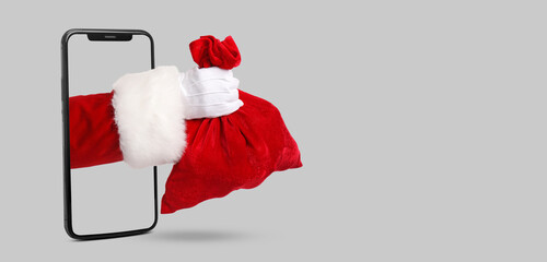 Hand of Santa Claus with bag on white background