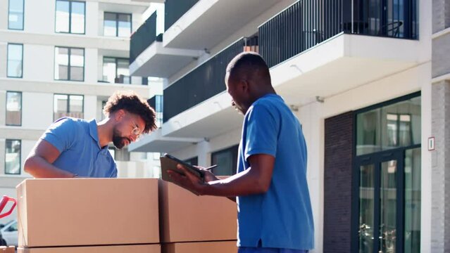 Movers Checking Delivery Boxes