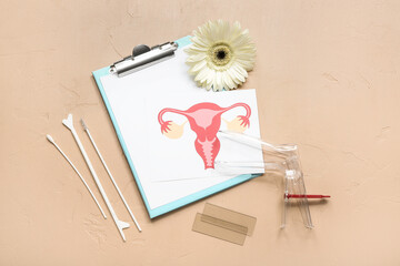 Gynecological speculum, drawing of female uterus, clipboard and pap smear test tools on beige...
