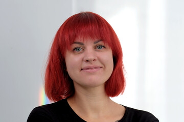 A young attractive woman with a short orange hairstyle