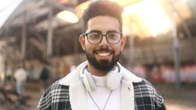 Close up portrait of carefree young indian man feeling good and satisfied enjoying great day at city street Self confidence businessman looking ahead feel proud achievement alone