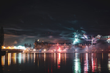 New Year's Eve midnight fireworks over the promenade of Peterhausen and the Rhine bridge, taken...