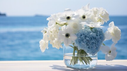 a serene arrangement of blue hydrangeas and white anemones, set against a backdrop of calm, azure waters. - obrazy, fototapety, plakaty