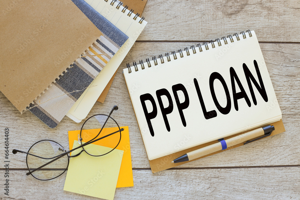 Poster paycheck protection program ppp loan. text on a notepad with a spring near a sticker with text