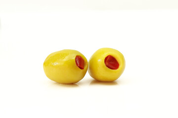 Two red paprika filled pickled olives isolated on white backgorund
