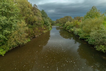 Roznovska Becva river in Valasske Mezirici in autumn cloudy evening