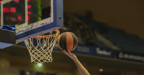 close-up of a hand clapping a basketball