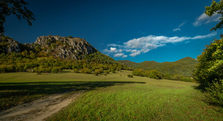 Meadows and hills in Strazovske hills in autumn cloudy day with green colors