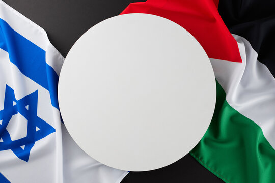 The essence of the Israeli-Palestinian dispute сoncept. Top view photo of Israeli flag, Palestinian flag on black background with blank circle for special text
