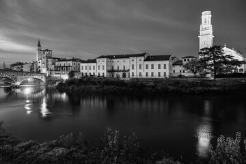 Verona, Veneto, Italy: Twilight view of Agige river waterfront with the Cathedral of St. Mary and the Stone Bridge and tower in black and white