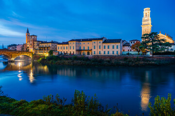 Verona, Veneto, Italy: Twilight view of Agige river waterfront with the Cathedral of St. Mary and the Stone Bridge and tower