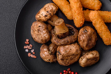 Delicious juicy whole champignons baked on the grill with salt and spices