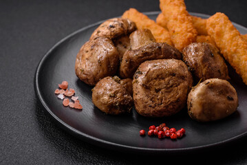Delicious juicy whole champignons baked on the grill with salt and spices