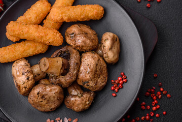 Delicious juicy whole champignons baked on the grill with salt and spices