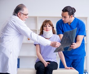 Fototapeta premium Two doctors examining young woman