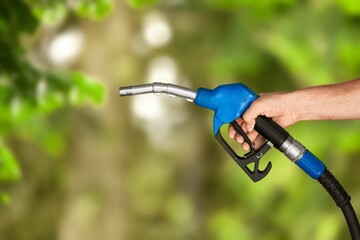 Naklejka premium Hand with classic fuel nozzle, decarbonization concept